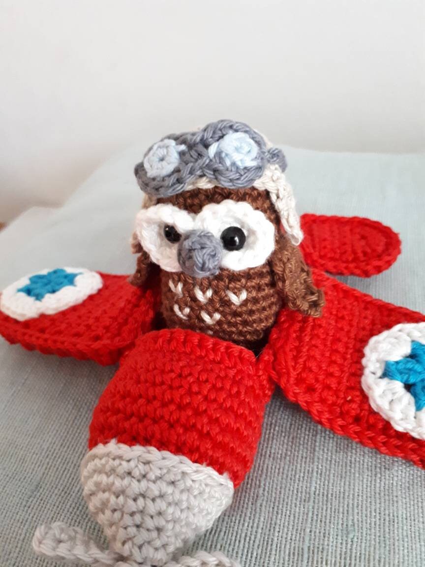 Red airplane with owl stuffed toy