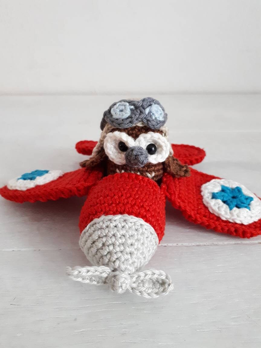Red airplane with owl stuffed toy